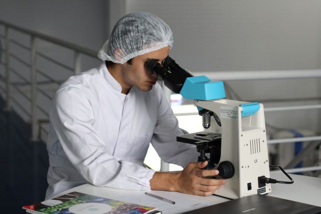 doctor looking on microscope
